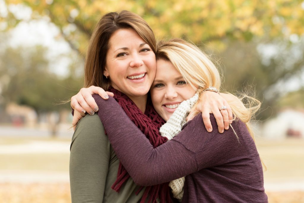 Mother and daughter hugging.