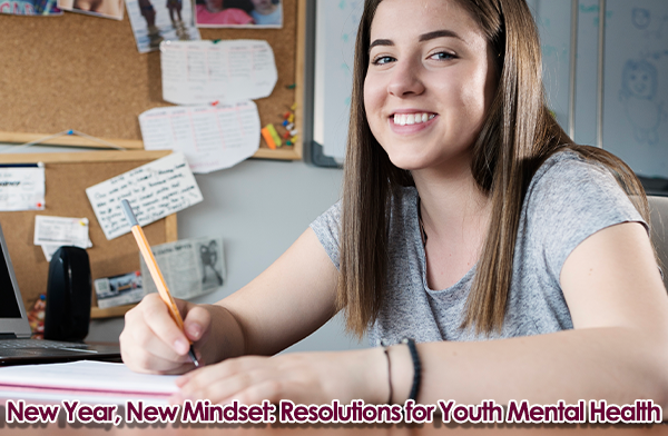 Young girl writing her New Year's Resolutions.